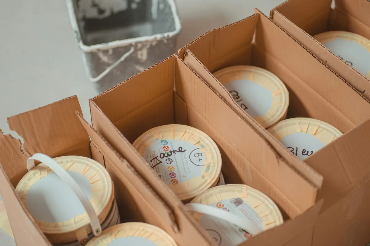 Ceramic bowls and dishes packed upright inside open cardboard boxes