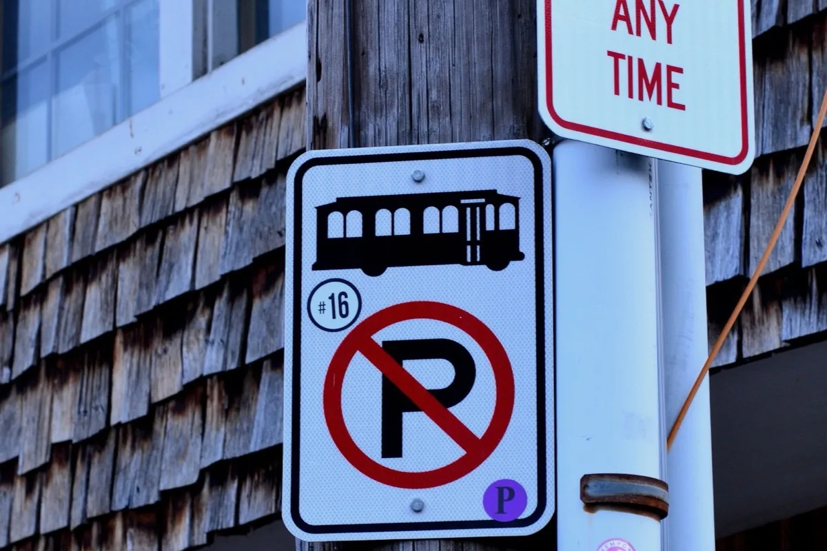 No parking street sign mounted above a marked kerb
